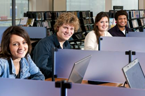 Students on computer smiling